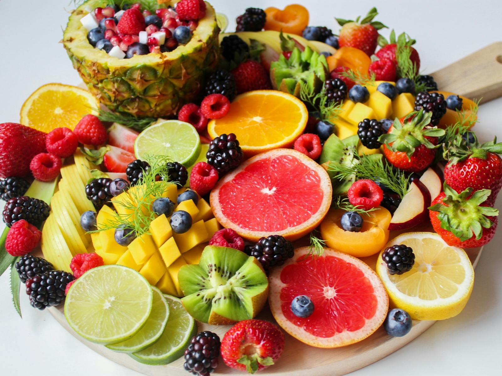 A vibrant assortment of fresh fruits beautifully arranged on a platter, perfect for a healthy and delicious snack.