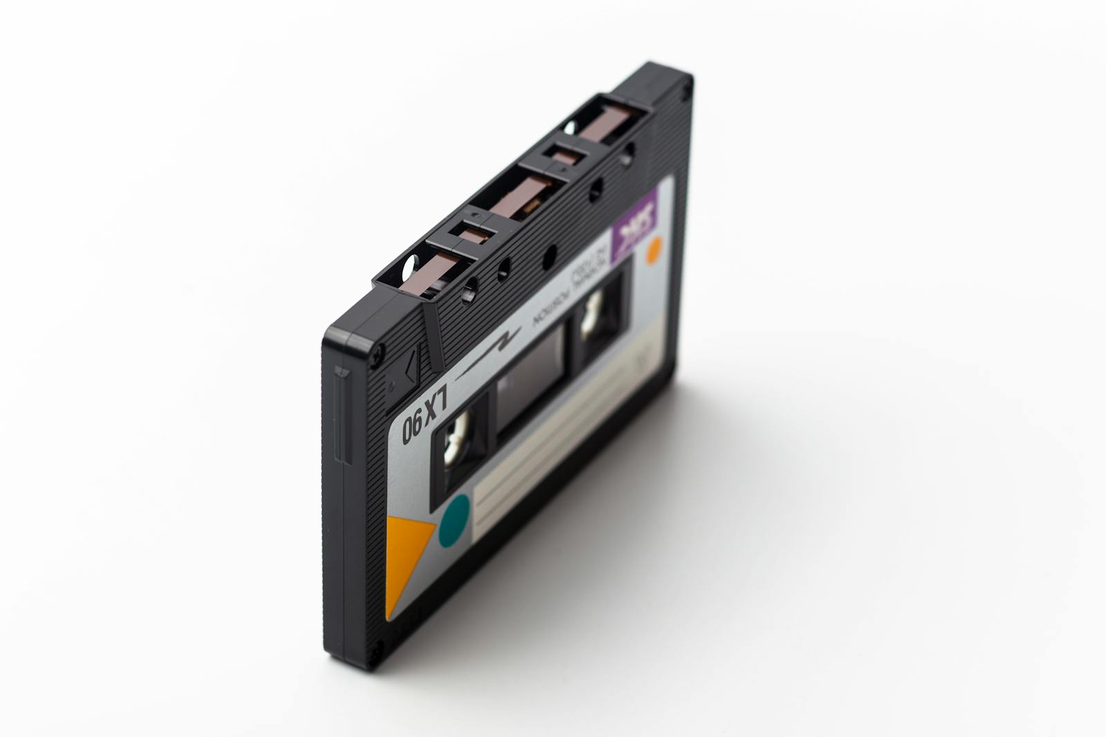 A classic retro cassette tape isolated on a white backdrop, representing 90s music technology.