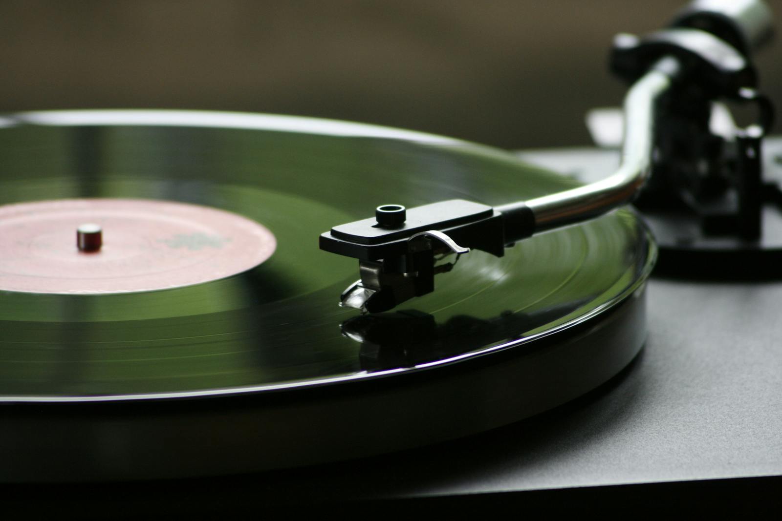 A close-up view of a rotating vinyl record on a vintage turntable player.