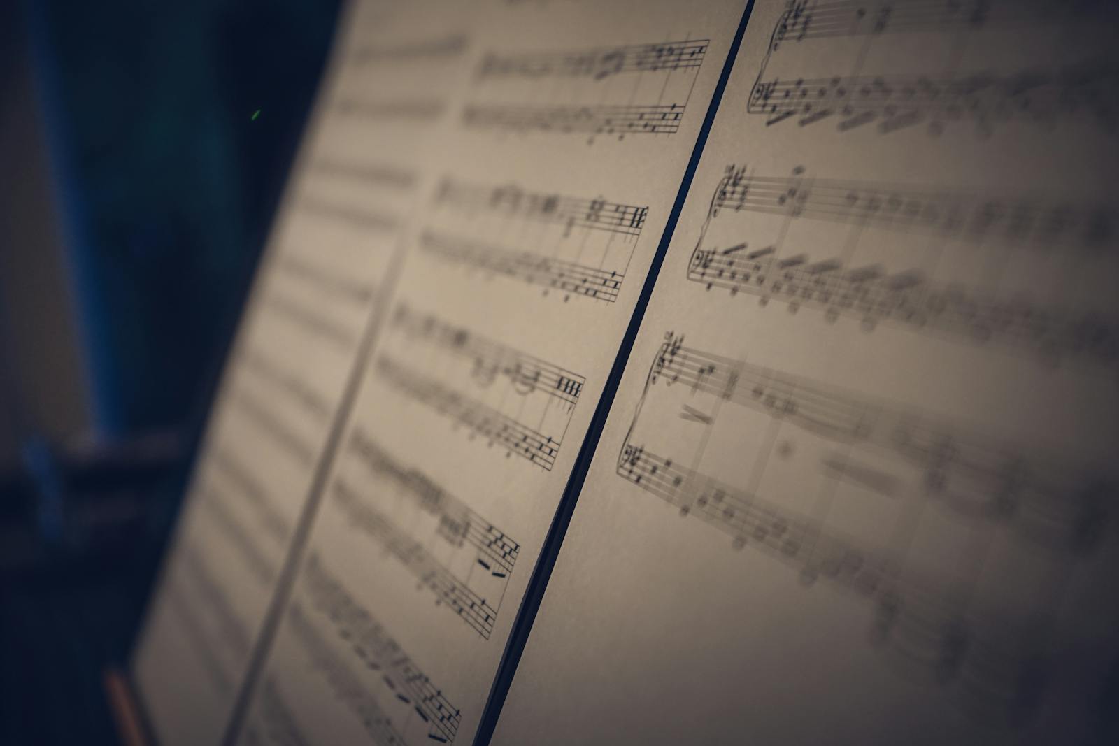 Close-up image of musical sheet music in soft focus with moody lighting, perfect for artistic concepts.